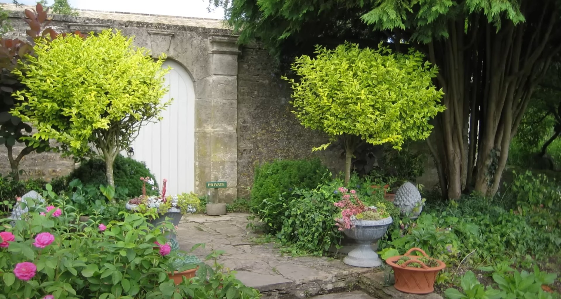 Garden Entrance Design with Stone Archway Elegant garden entrance with stone archway and lush plantings